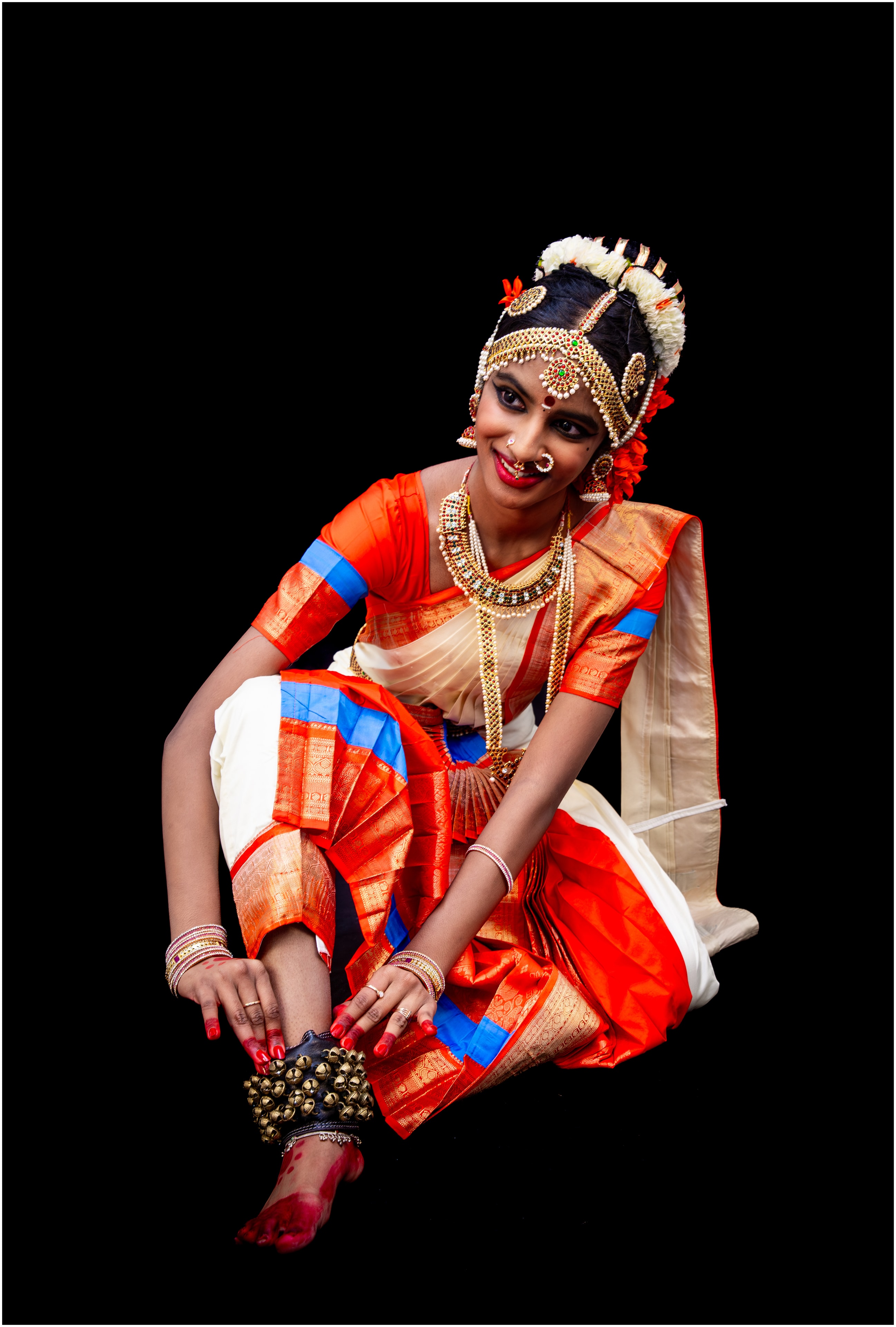 Keerthana — orange and cream costume, ghungroo detail