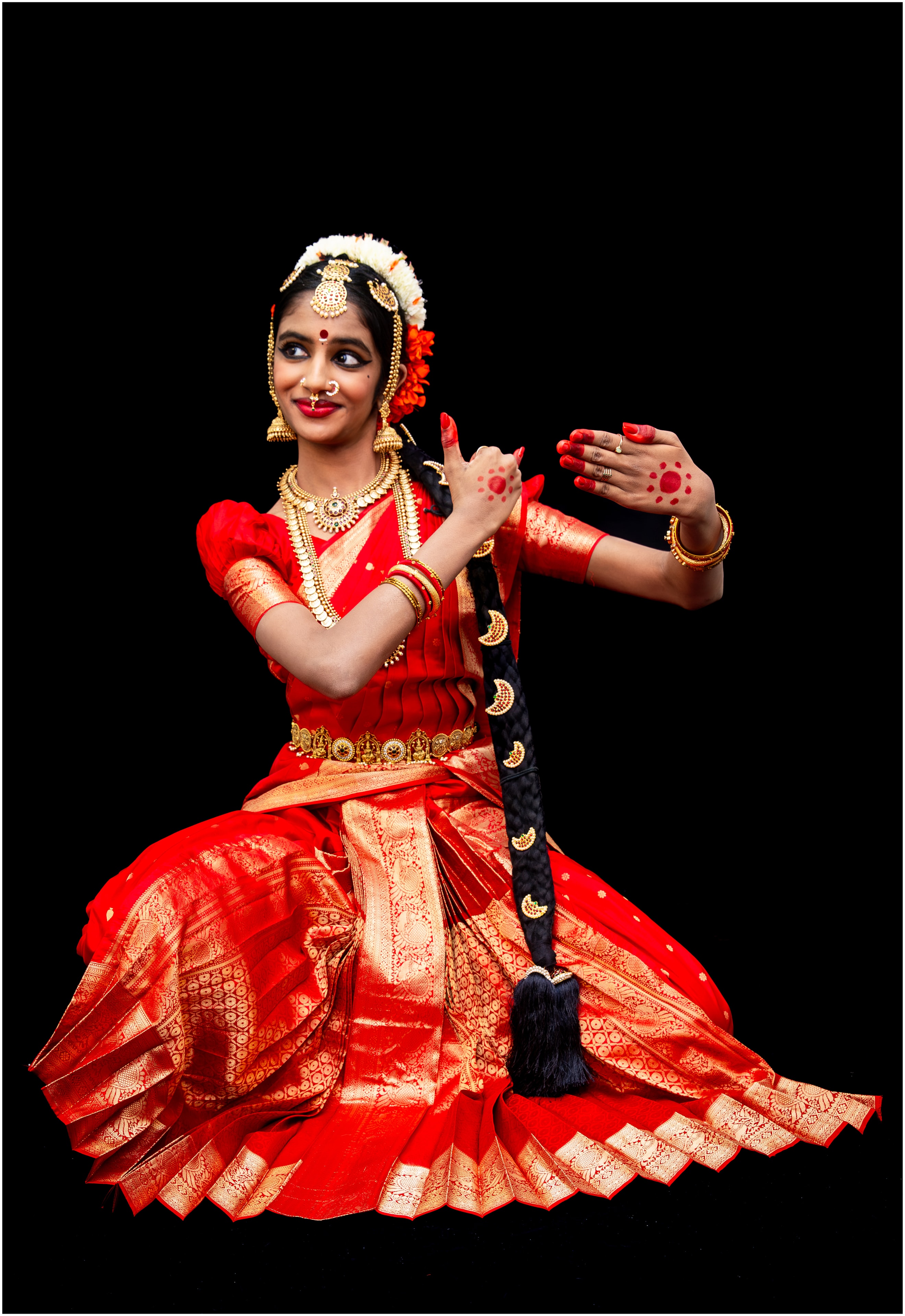 Red costume — expressive seated pose with braid