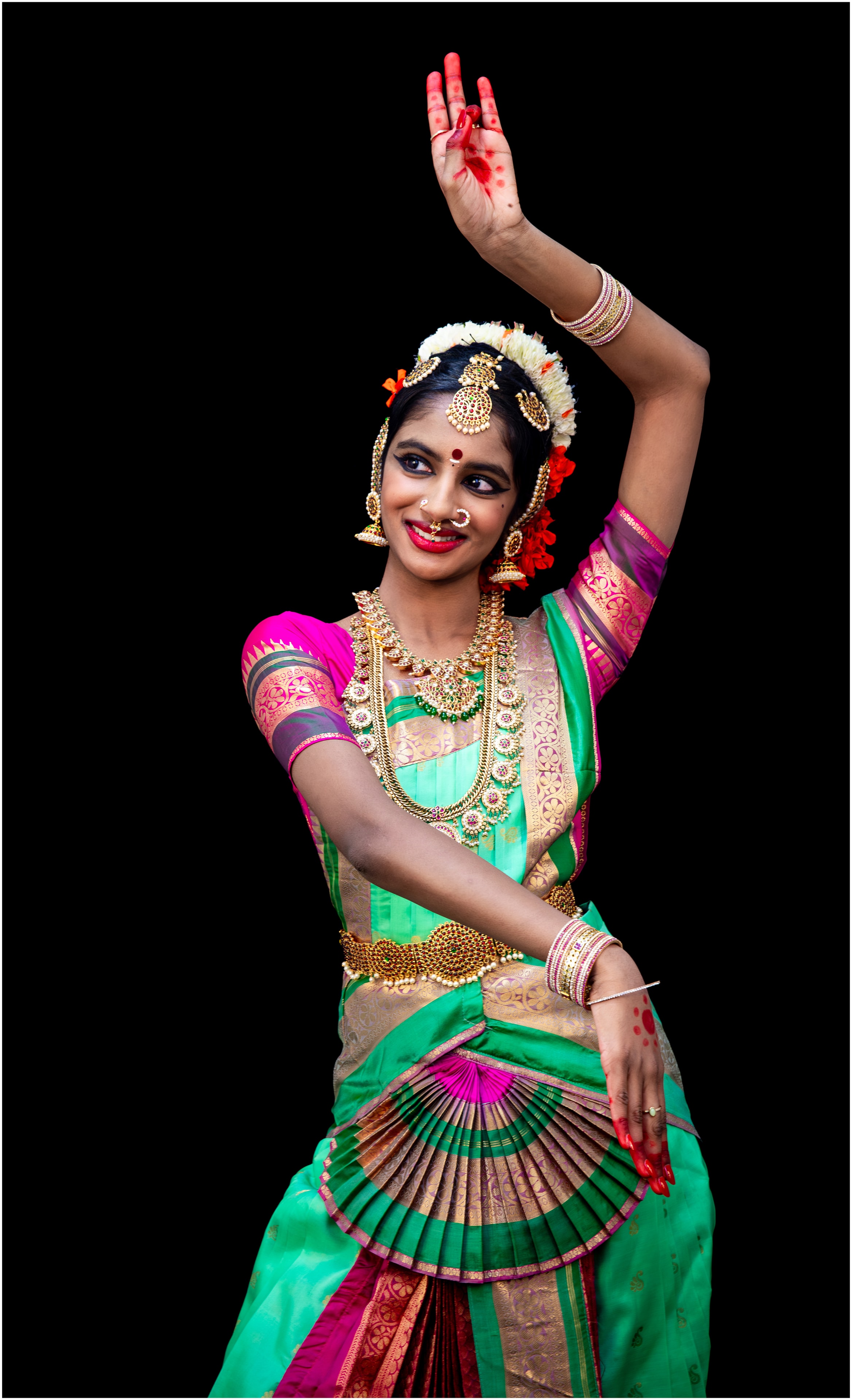 Teal costume — raised arm, graceful expression